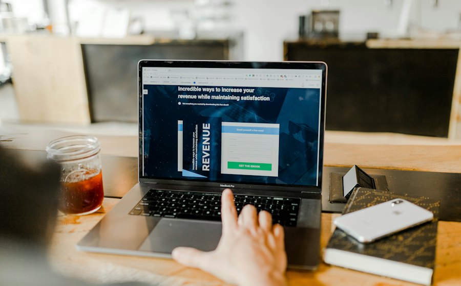 Laptop on a desk with a revenue report